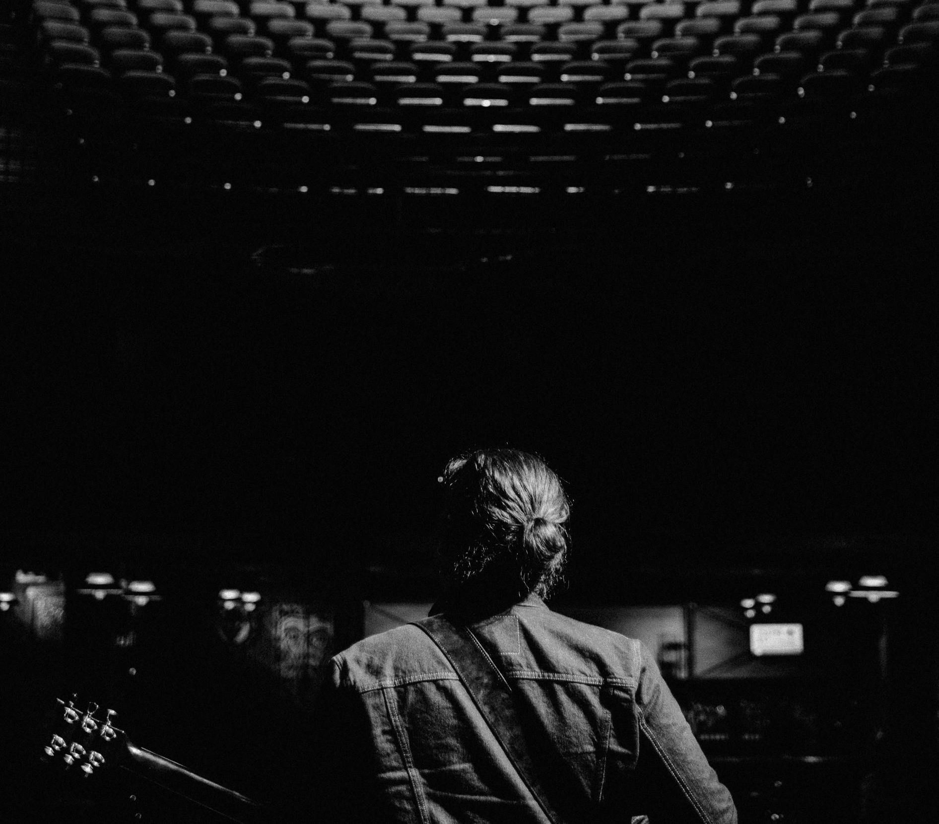 A black and white photo of a man playing a guitar