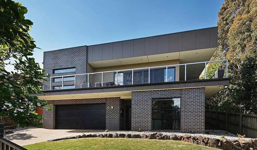 A Large Brick House with a Black Garage Door | Warragul, VIC | ADI Building Services