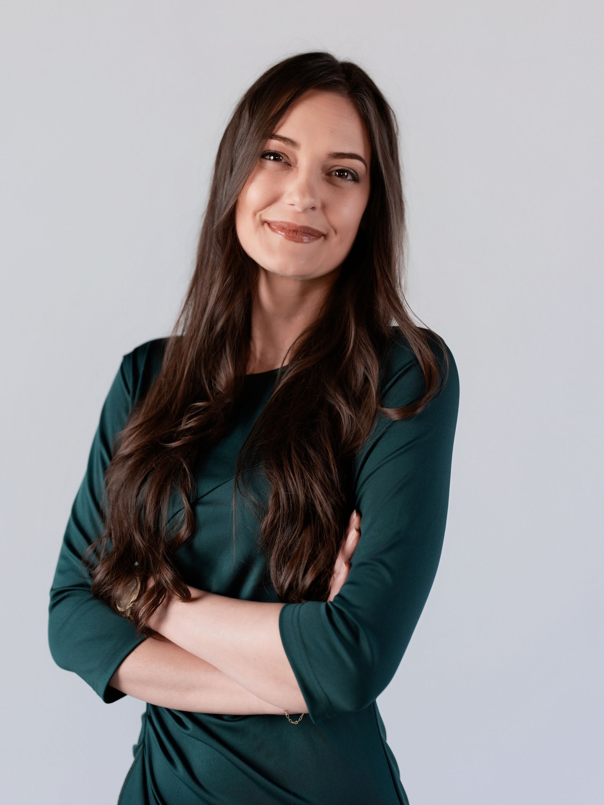 A woman in a black shirt is smiling for the camera.
