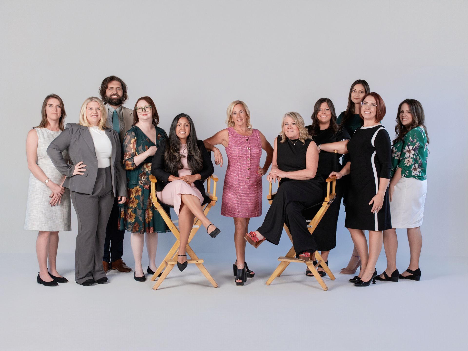 A group of people are posing for a picture while sitting on a couch.
