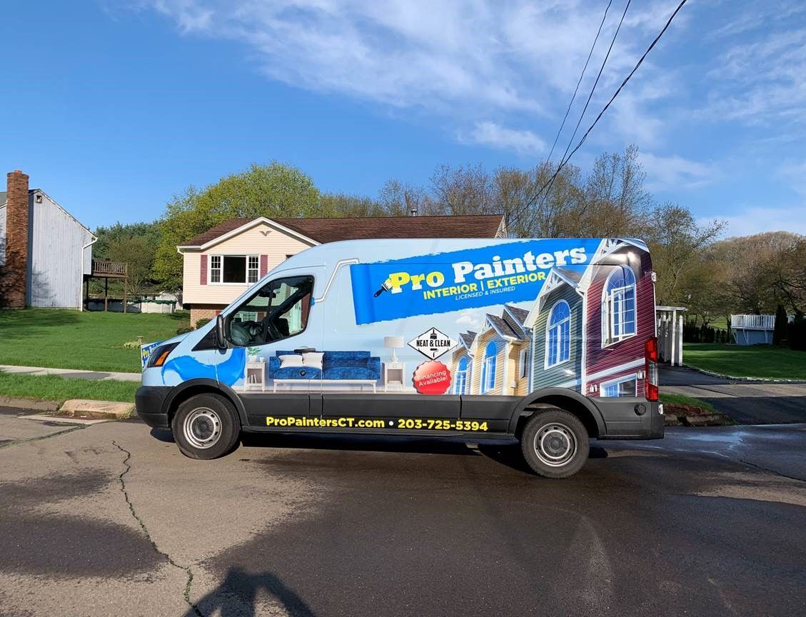 Pro Painters service van parked on a residential street beside a house