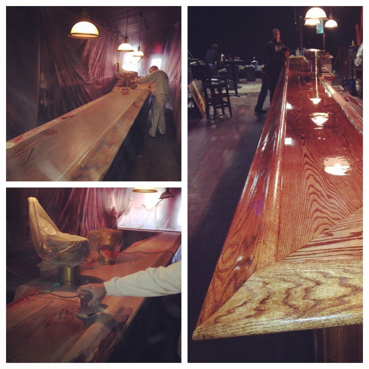 Long polished wooden bar counter under warm lights in a dimly lit room