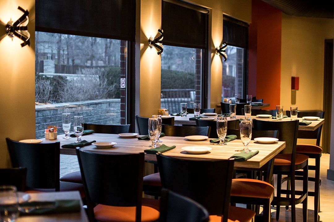 a restaurant with tables and chairs and a large window