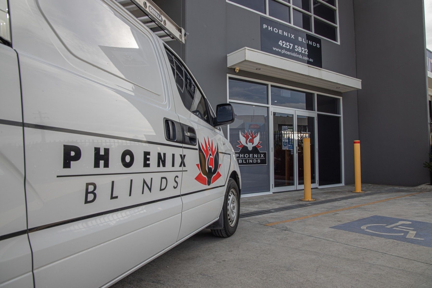 A phoenix blinds van is parked in front of a building. — Phoenix Blinds In Albion Park Rail, NSW