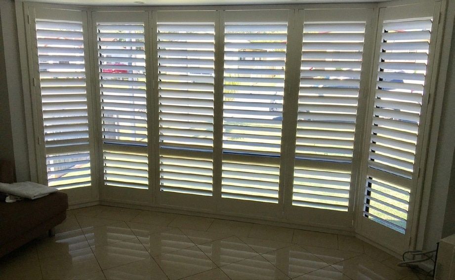 A Living Room with White Shutters — Phoenix Blinds In Albion Park Rail, NSW