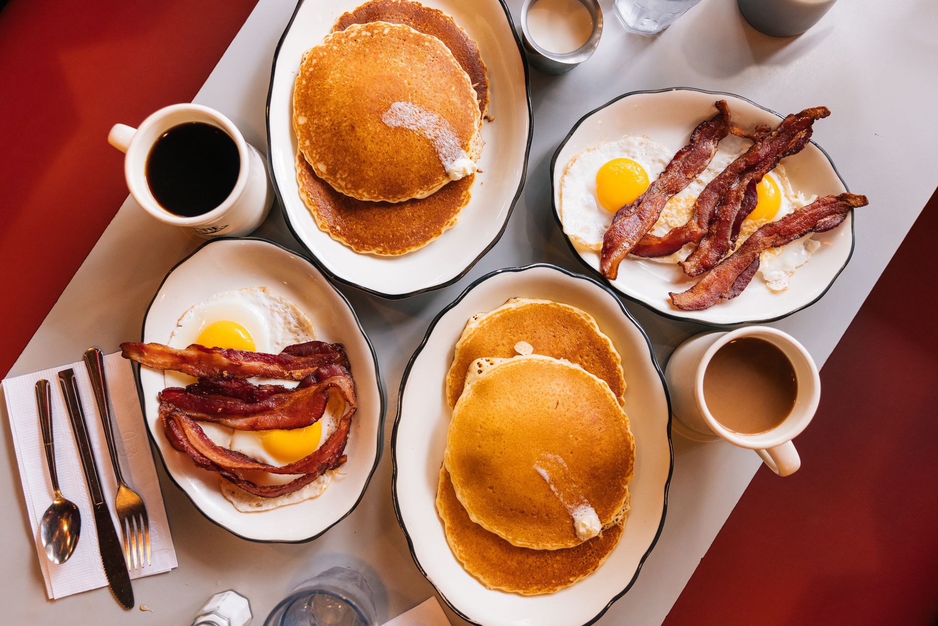American breakfast at a local restaurant in Springfield, MA with fried eggs, bacon and pancakes.