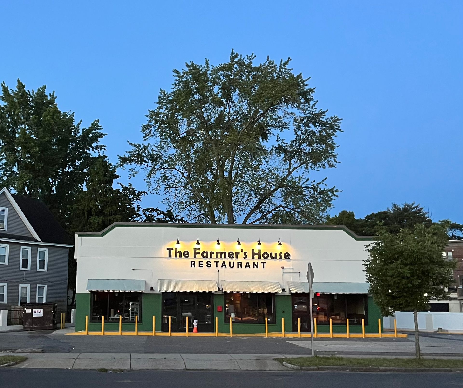 The farmer 's house restaurant is lit up at night