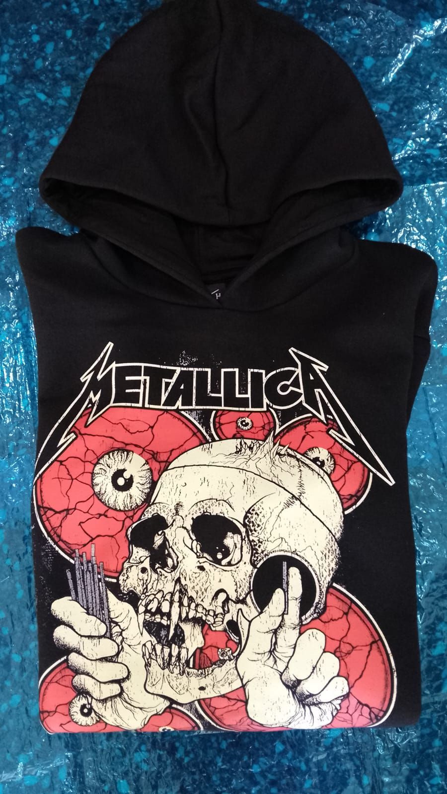 Sudadera negra con capucha y un gráfico de una calavera de Metallica en rojo, blanco y negro.