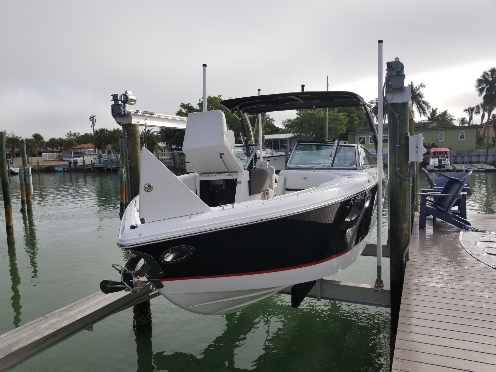 Black and white boat on a lift after a full detail.