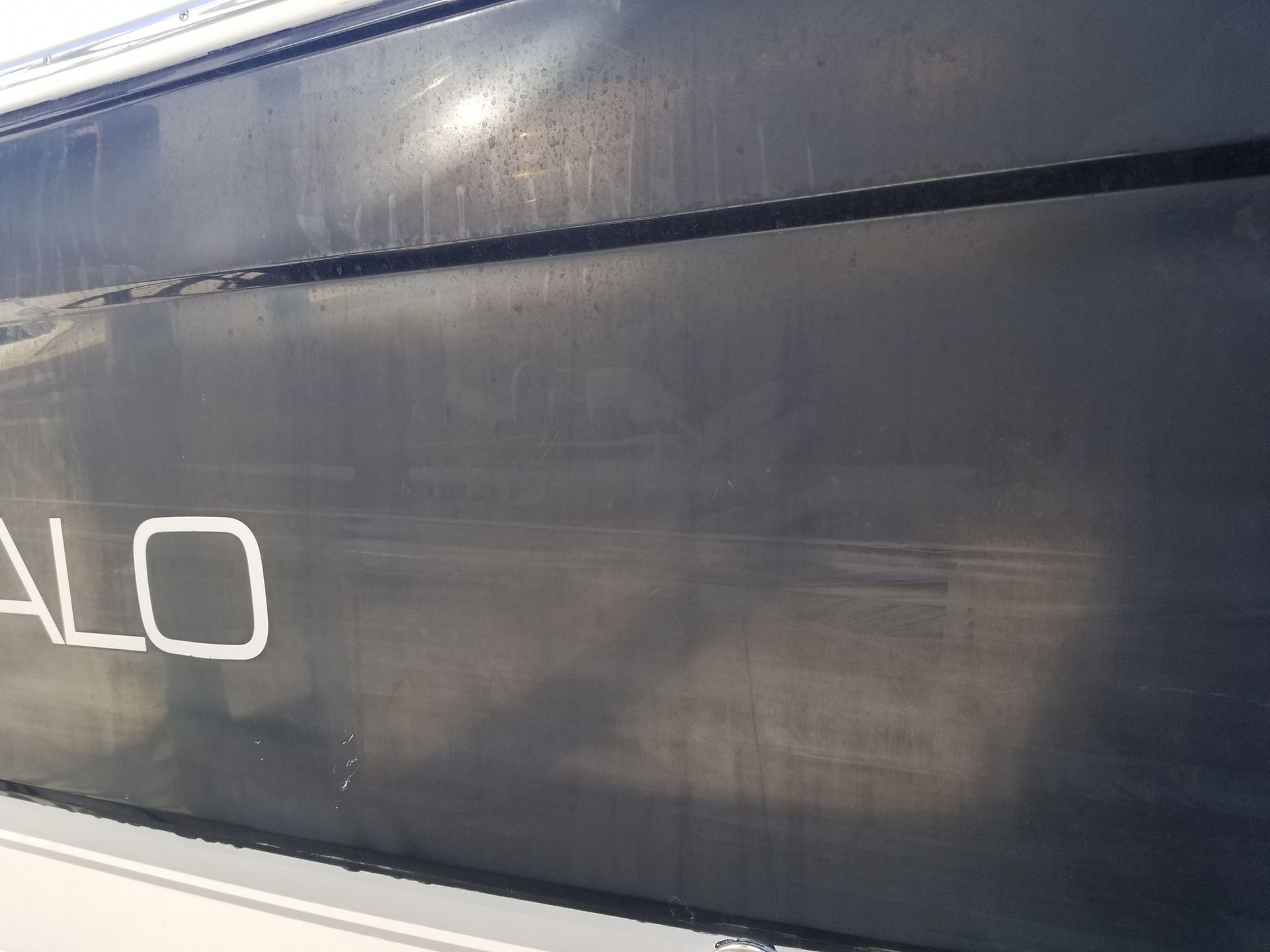 A close up of the side of a boat with the word alo written on it.