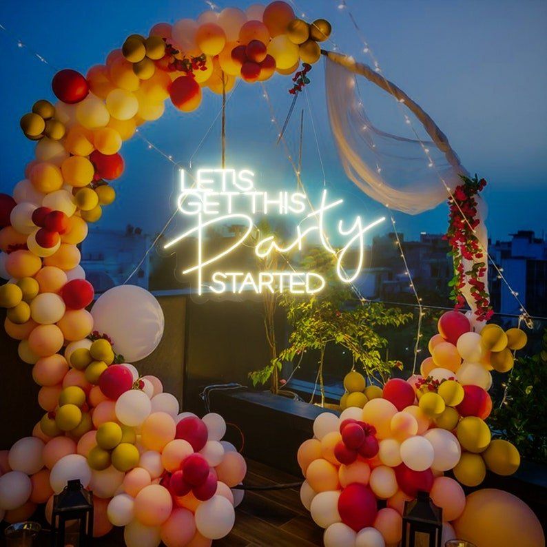 A neon sign that says let 's get this party started