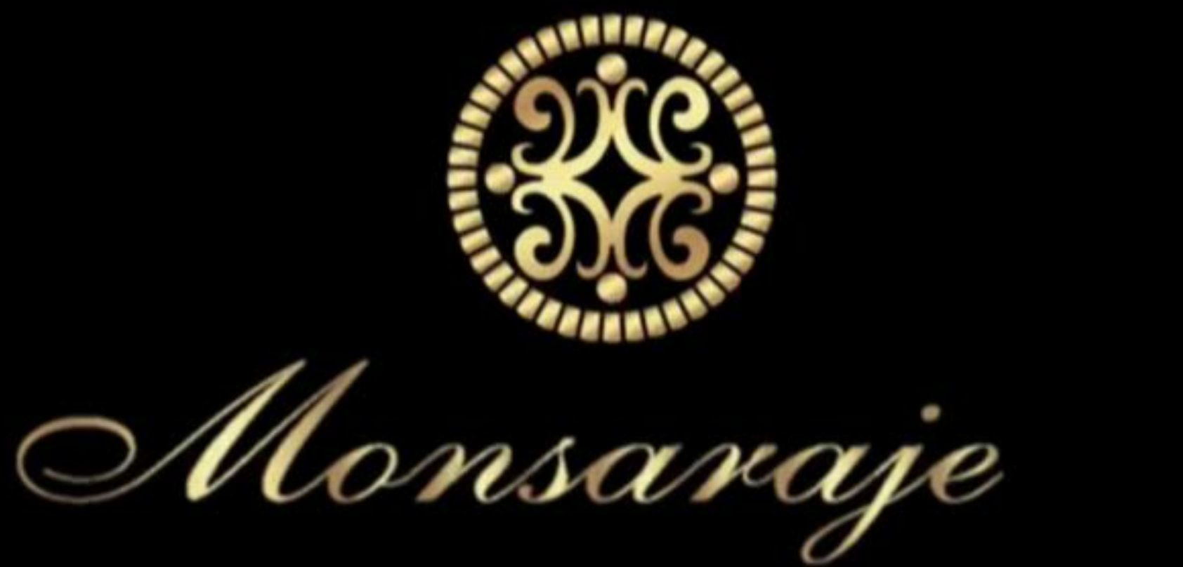 A gold monsaraje logo on a black background
