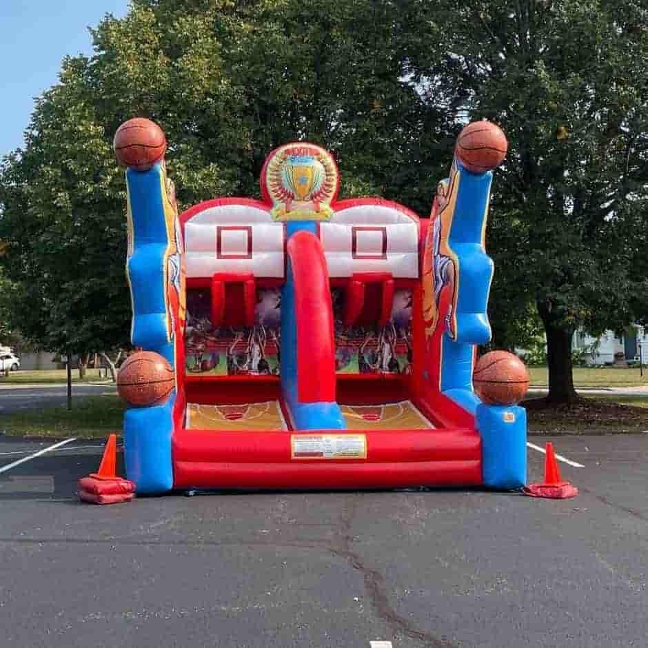 An inflatable basketball hoop is in a parking lot