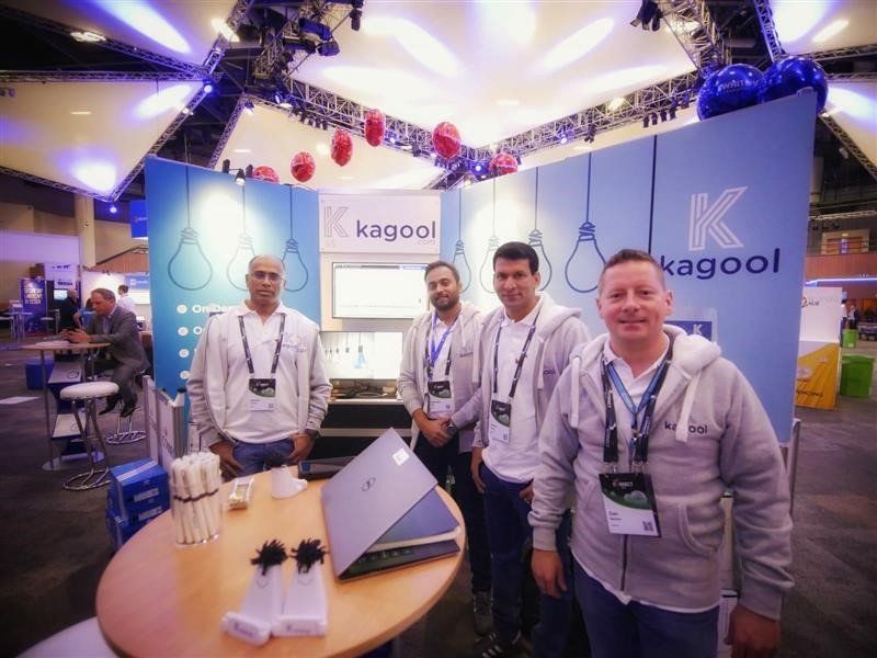 A group of men standing in front of a kagool booth