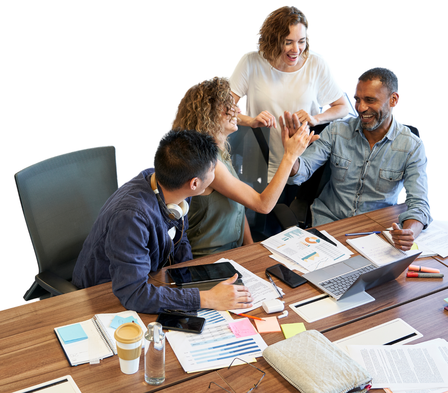 A group of people are sitting at a table giving each other a high five.