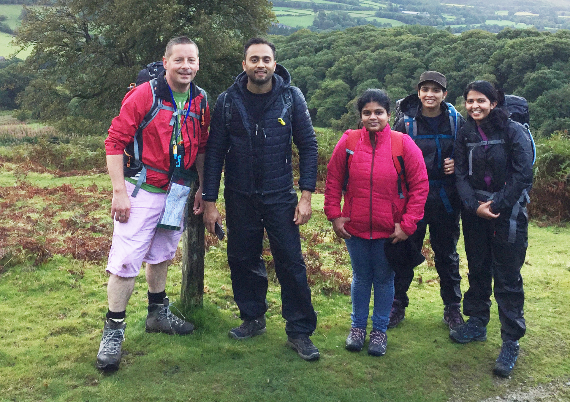 A group of people are standing next to each other in a field.
