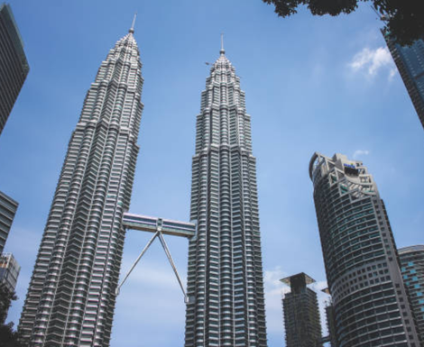 An aerial view of a city with a tall building in the foreground