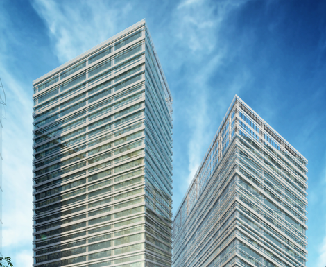 Two tall buildings with a blue sky in the background