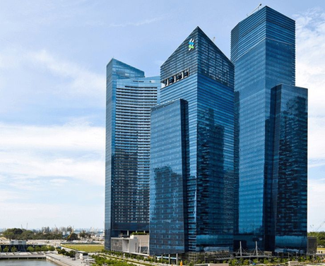 A group of tall buildings are sitting next to each other in a city.