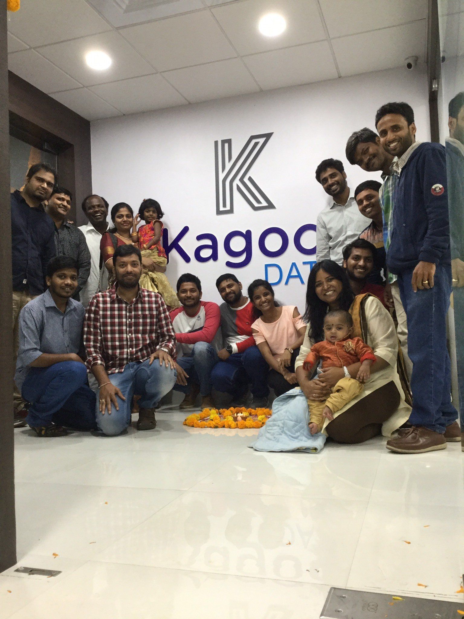 A group of people are posing for a picture in front of a sign.