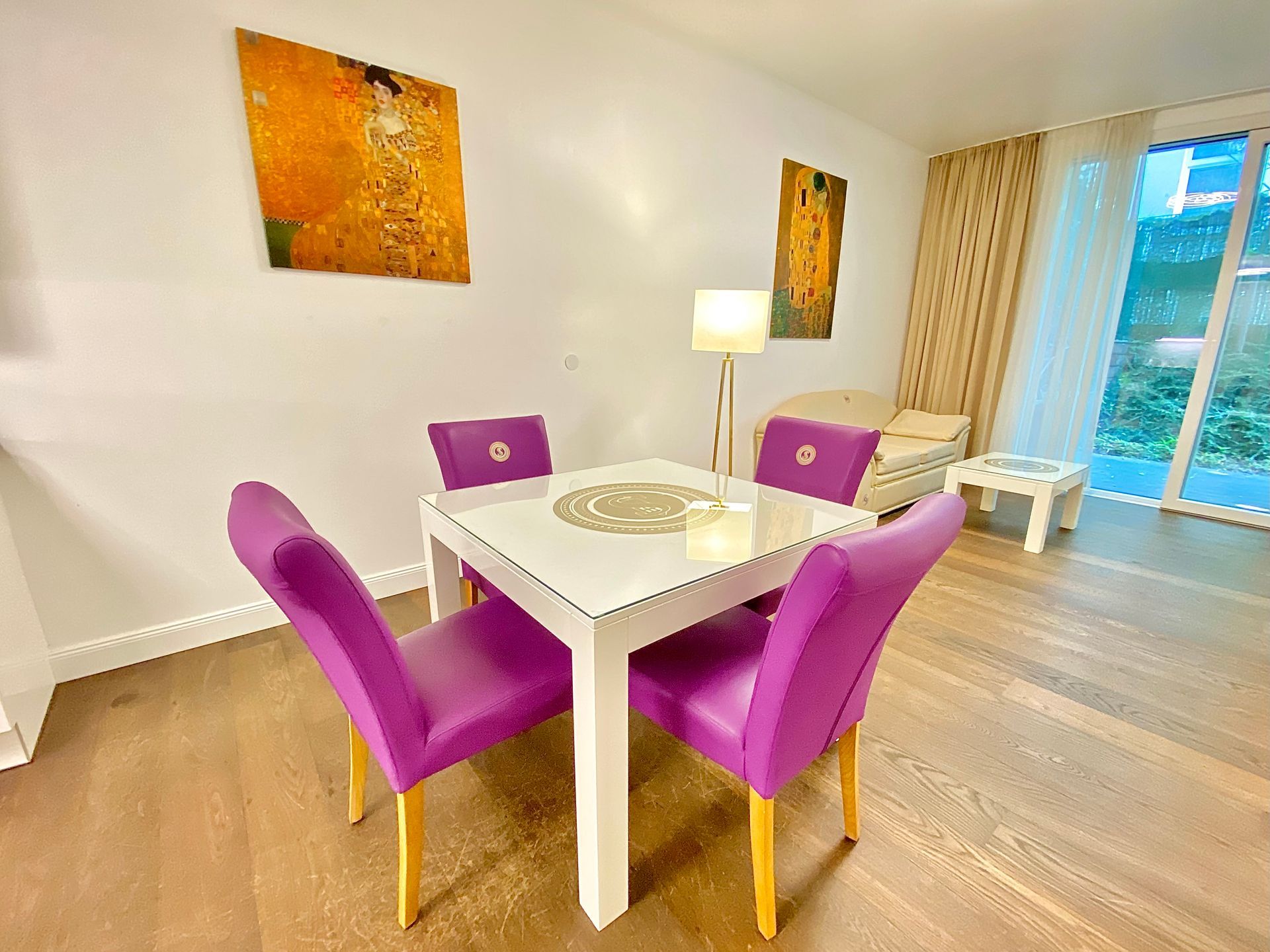 A living room with a dining table and purple chairs.