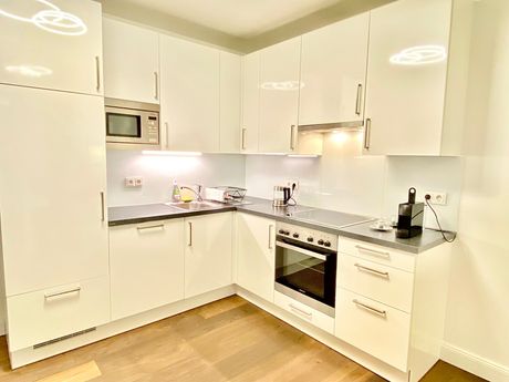 A kitchen with white cabinets and stainless steel appliances.