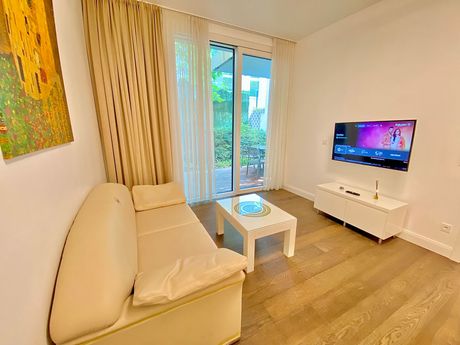 A living room with a couch , table and television.