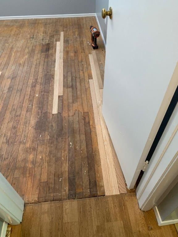A room with a wooden floor and a door.