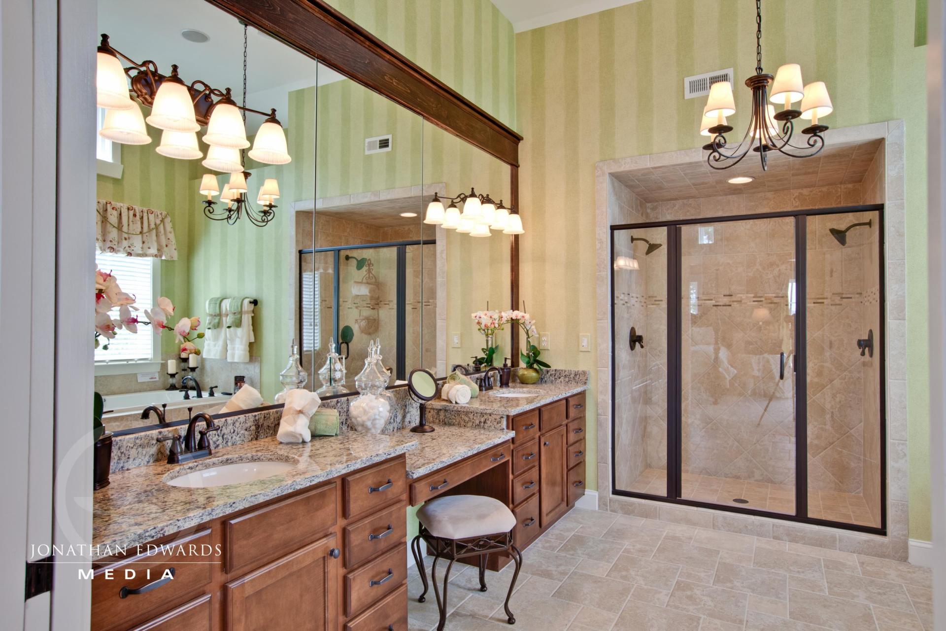 Elegant bathroom with green walls and brown cabinets  | Bathroom Gallery | Stephen Alexander Homes | Chesapeake, VA