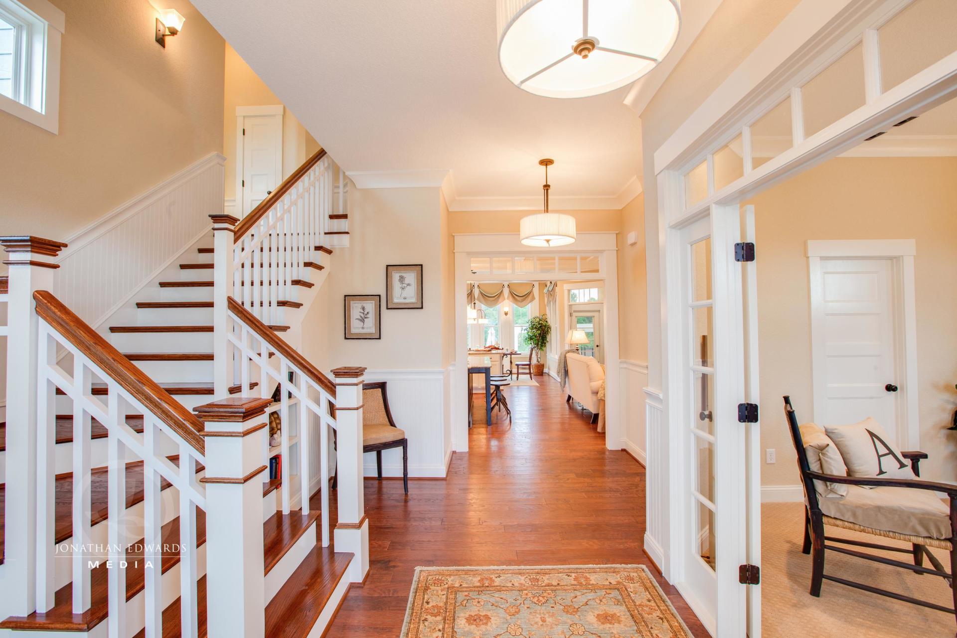 Elegant living area hallway with stairway view  | Living Spaces Gallery | Stephen Alexander Homes | Chesapeake, VA