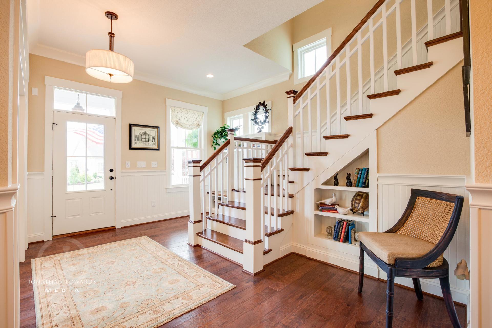 Elegant front entry area with staircase view | Living Spaces Gallery | Stephen Alexander Homes | Chesapeake, VA