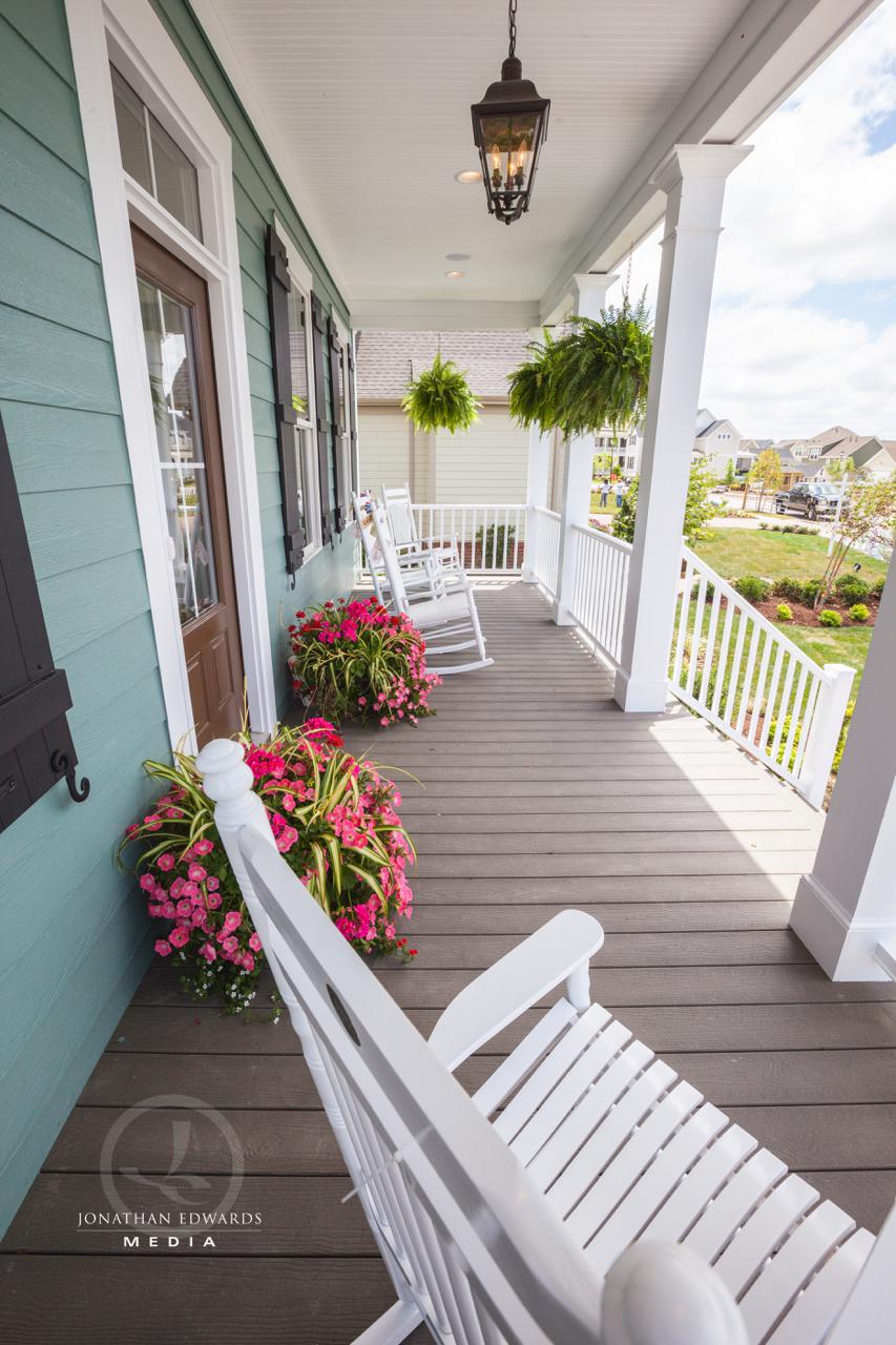 Elegant front porch covered seating in exterior of green home  | Exterior Gallery | Stephen Alexander Homes | Chesapeake, VA