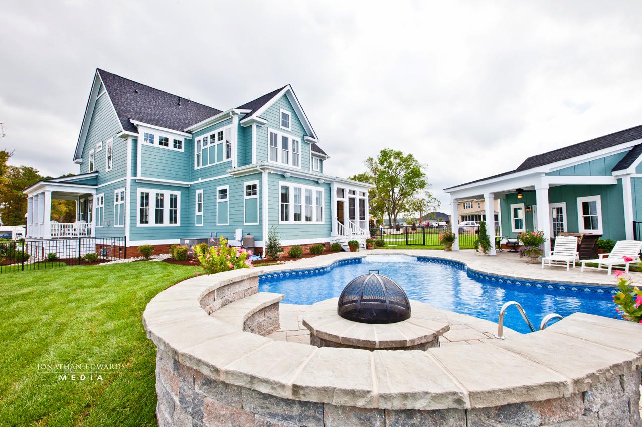 Elegant exterior of light blue home with pool  | Exterior Gallery | Stephen Alexander Homes | Chesapeake, VA