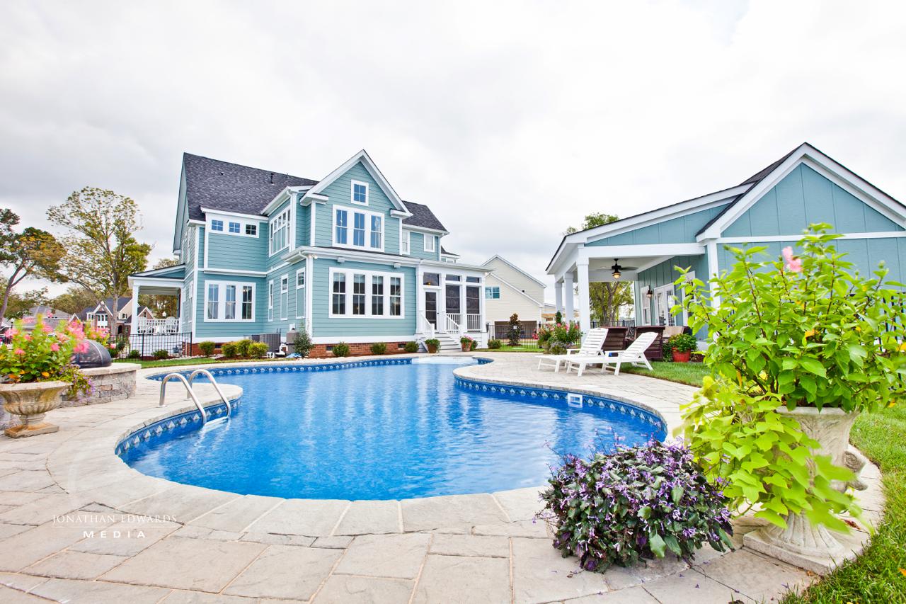 Elegant exterior of  light blue home with pool  | Exterior Gallery | Stephen Alexander Homes | Chesapeake, VA