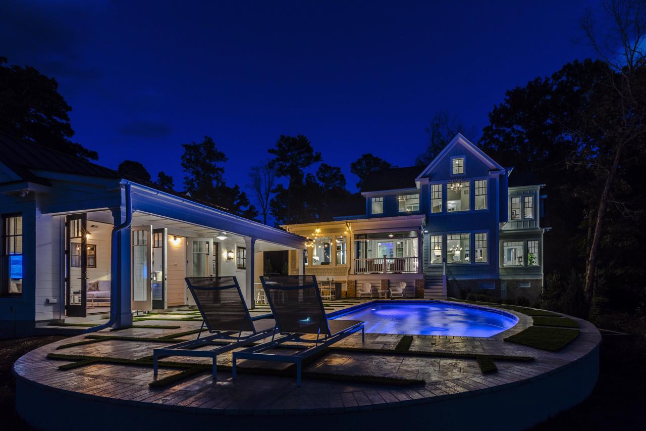 Evening view of elegant rear exterior of home  with pool| Exterior Gallery | Stephen Alexander Homes | Chesapeake, VA