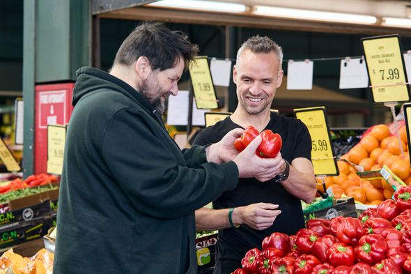 Two men are shopping for capsicums 