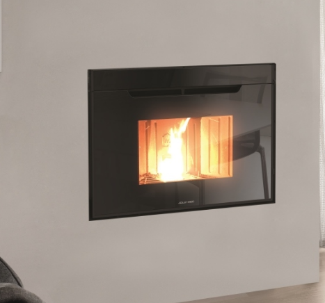 Un camino nero da incasso con parte anteriore in vetro, fiamme che ardono all'interno, incastonato in una parete bianca.