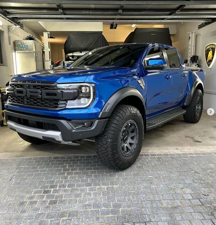 blue ford raptor is parked in a garage after a ceramic coating has been applied for paint protection in castle hill district