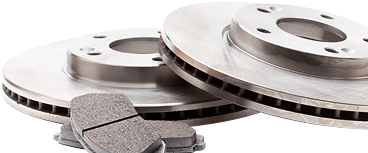 A pair of brake rotors and brake pads on a white background. | Beacon Auto Repair Center