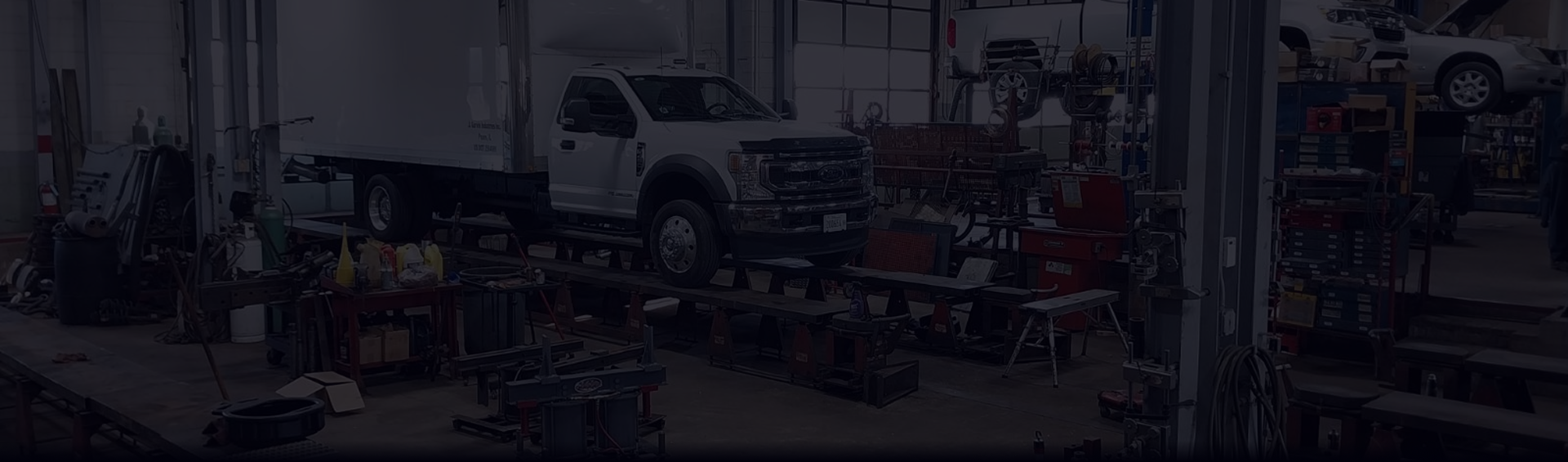 A blurred image of a garage with a truck in the background. | Beacon Auto Repair Center