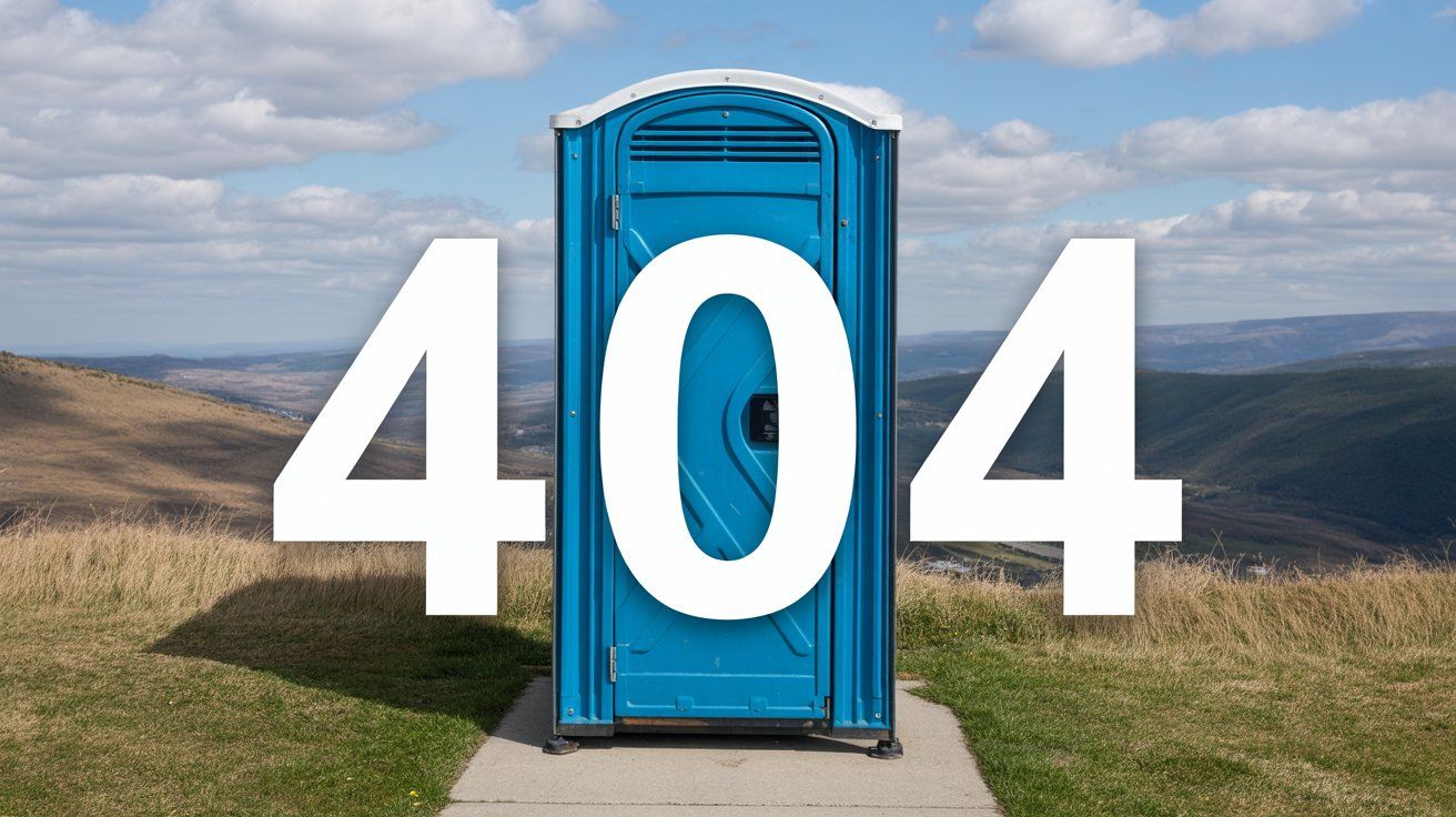 Blue porta-potty in grassy field, 