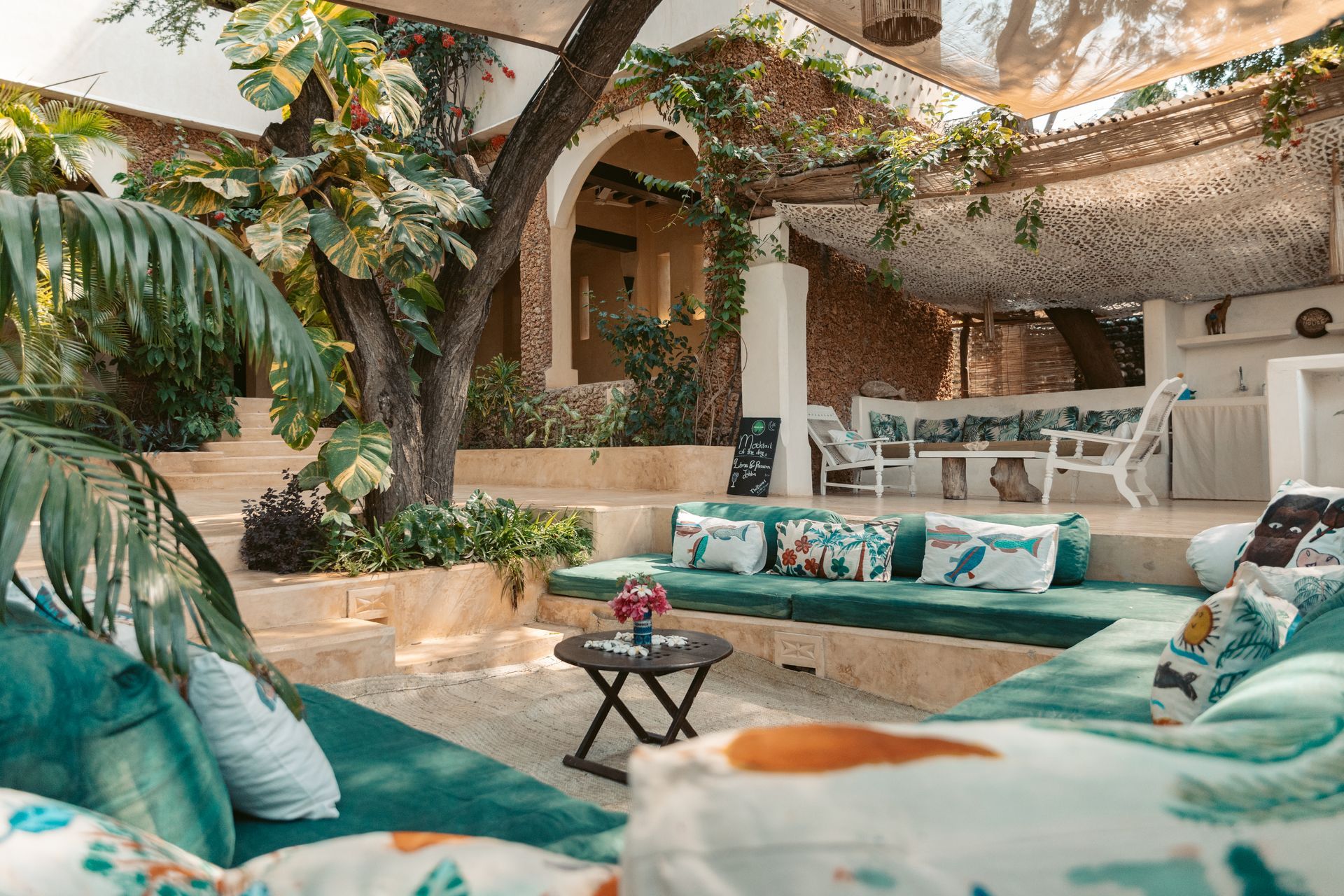 Outdoor seating cafe under shade in tropical garden