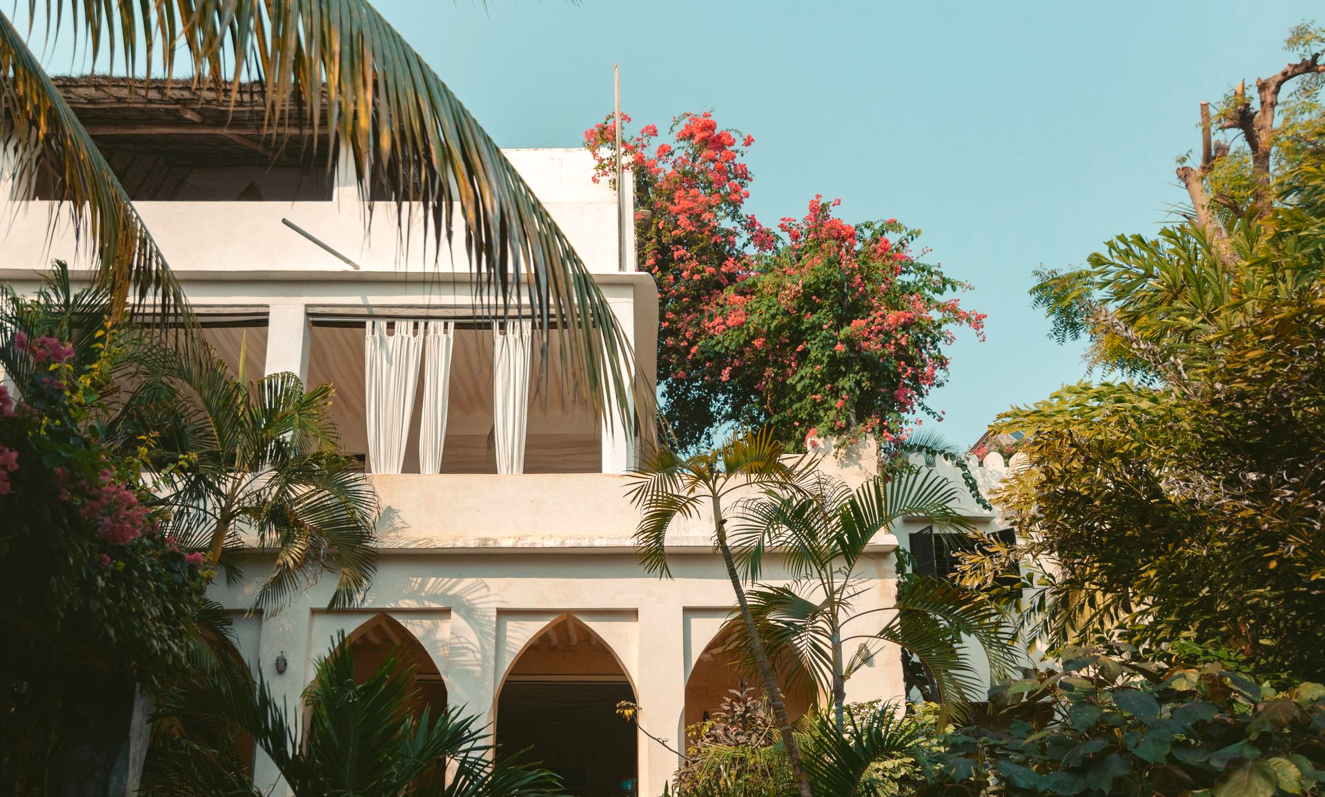 Banana House courtyard with arches and tropical garden