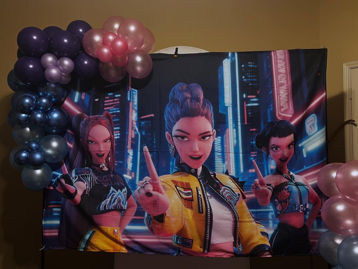 Colorful game-themed banner with three stylized characters and balloon clusters at the edges