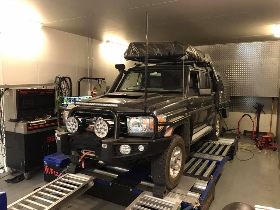 Black Car Sitting on Ramp in Garage — Ulladulla, NSW — B & D Automotive Repairs