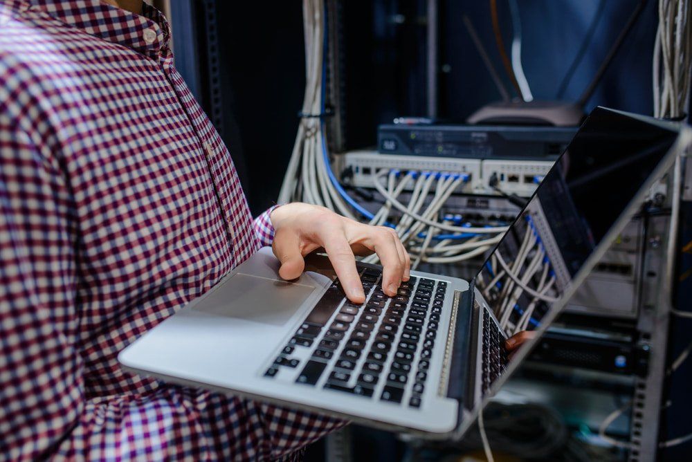 Technician Fixing The Connection Of Network In The Server Room — Network Cabling in Tamworth, NSW