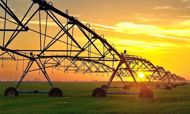 Irrigation Pivot System On The Wheat Field At Sunset — Rural Electrician in Tamworth, NSW