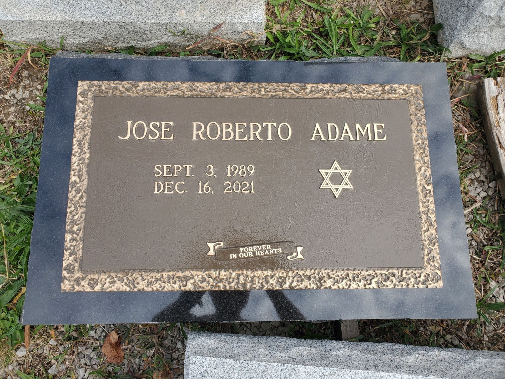 Bronze grave marker for Jose Roberto Adame, with Star of David, dates Sept. 3, 1989 - Dec. 16, 2021.
