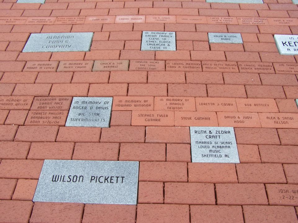 Bricks paved walkway, some with engraved name plaques. One reads