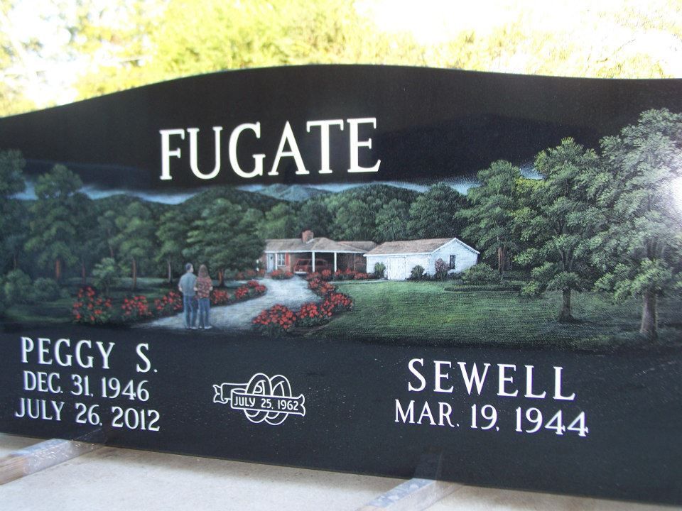 Black headstone for the Fugate family, with painted house scene and dates of birth and death for Peggy S. and Sewell.